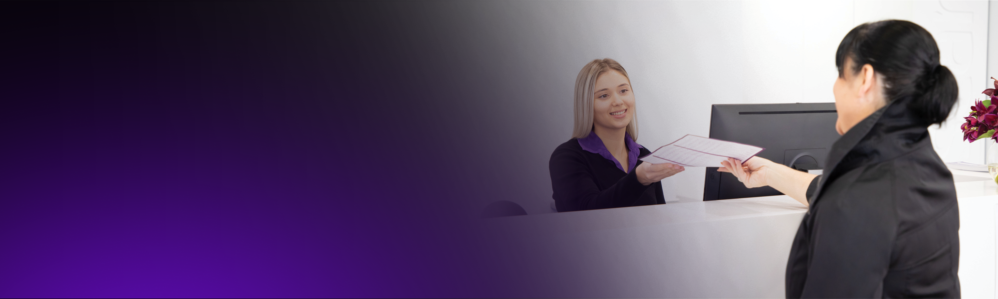A Qscan receptionist talks to a patient